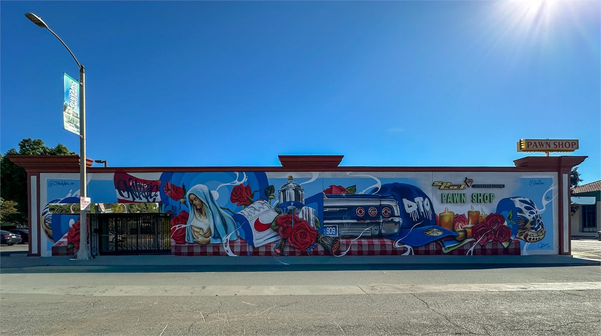 Completed blue mural across a Downtown Ontario storefront