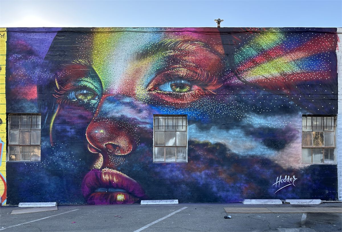 Completed colorful cosmic portrait mural in Downtown Ontario