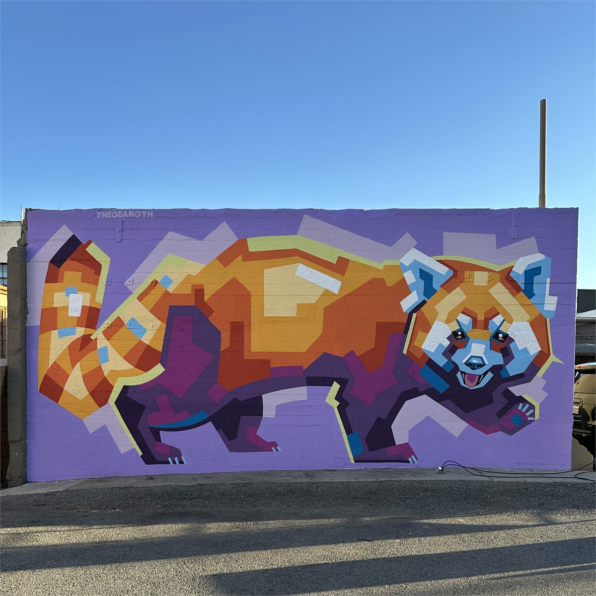 Completed colorful red panda mural in Downtown Ontario